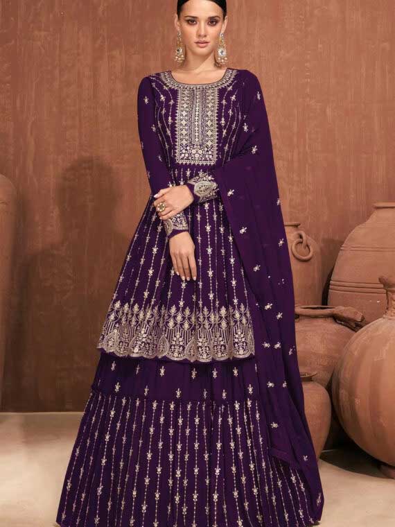 One of our most stunning outfits is the Purple Pakistani suit with embroidered floral work. This elegant suit is made with raw georgette and features an embroidered border dupatta in nazmin. The full work bell sleeves and drawstring closure provide both comfort and style.