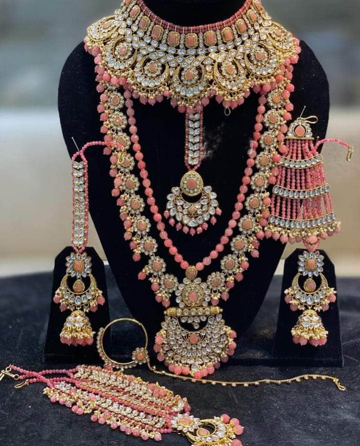 Pink Stones Beautifull Kundan Gold Plated Bridal Jewellery Set By Zevar.
Perfect set to wear on your Big and special day
This Bridal Set Consists 1 Long Necklace, 1 Short Choker, 1 pair of Earrings, 1 pcs of Mathapatti, 1 pcs of Nose Ring.
Designer and Trendy Necklace & Earrings, perfect for all occasions.
The Product is made from Non Allergic Metal thus making it safe to wear