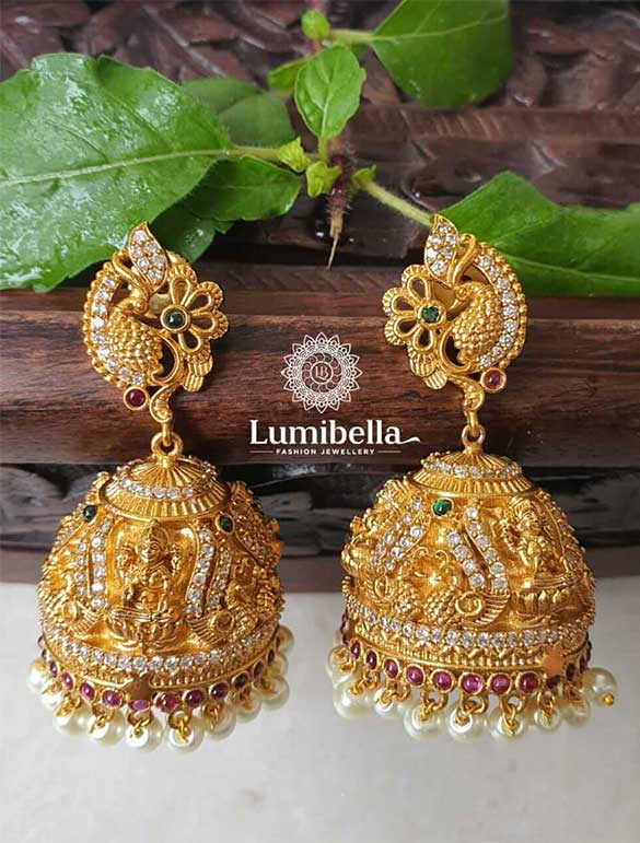 Finish:
Gold Plating on brass and alloy base material. Faux semi-precious stones and pearls are embellished. 

Product description: Temple Jewelry Design Jhumki is a flawless imitation of Temple sculptures, as its name suggests. Peacock motif is used to make the stud on the earring. bedecked in ice-white crystals. The peacock